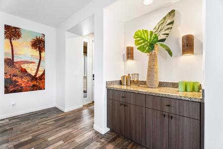 Tropical touches and warm finishes make this hallway feel like home.