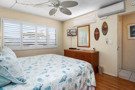 The bedroom features a king-sized bed, split AC and ceiling fan.