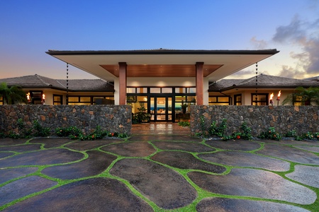 Grand entryway with a unique lava stone pathway leading to a luxurious island retreat.