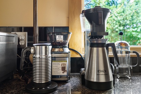 Wake up to your perfect cup with premium coffee equipment ready for your morning ritual in this well-appointed kitchen.