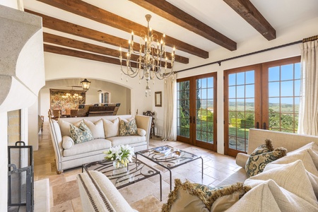 The formal living room offers comfortable seating and breathtaking views of the vineyards