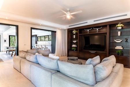 Stylish entertainment room with a comfortable sectional sofa and built-in media center.