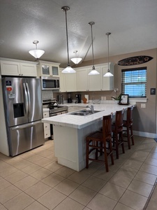 Modern kitchen with a spacious island and seating for 3.