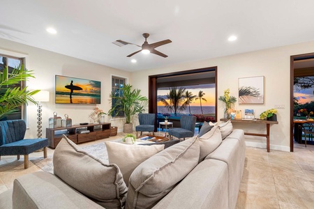 Inviting living room with plush seating and panoramic sunset views.