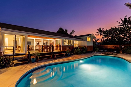 The pool glows blue against a violet Kona sky, the kind of evening you slow down for.