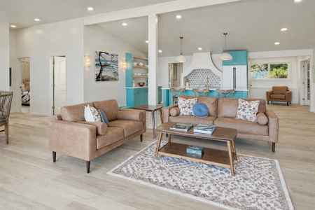 Sink into plush leather sofas in your spacious living area, where coastal-inspired turquoise accents and modern design create the perfect retreat.