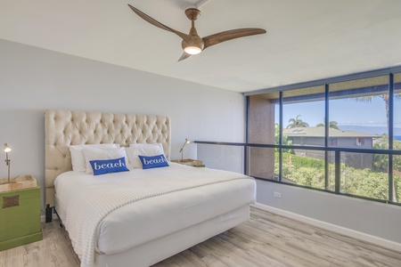 This bedroom also has ceiling fan, AC, outdoor views and TV.