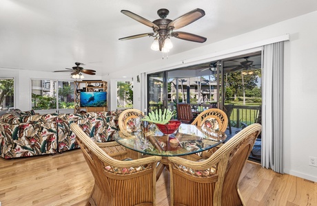 Gather in the tropical-inspired dining and living space where warm wood floors and rattan furnishings create your perfect island getaway.