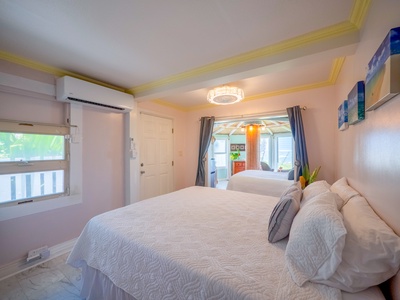 Drift off peacefully in your serene bedroom with plush bedding, warm lighting, and refreshing air conditioning for your ultimate comfort.