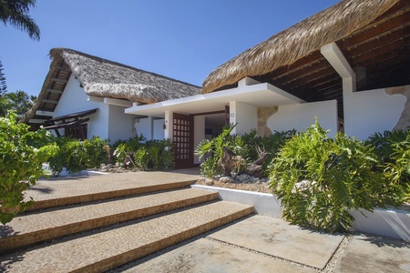 Welcoming entrance with lush greenery.