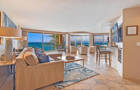Royal Kahana 610's living room offers comfortable seating with direct access to the lanai and beautiful ocean views.