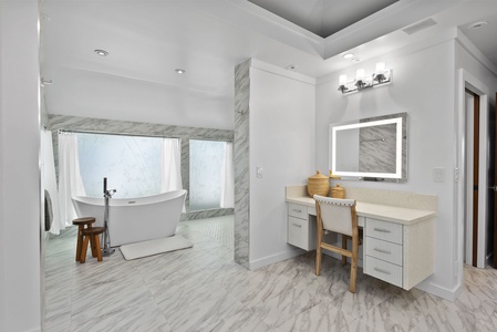 The spa-style ensuite bath in the primary suite includes dual vanities and a soaking tub set in marble elegance.