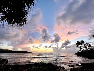 Evening shoreline with colorful sunset sky.