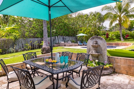 Dine al fresco in the spacious backyard, with plenty of seating for outdoor meals and relaxation.