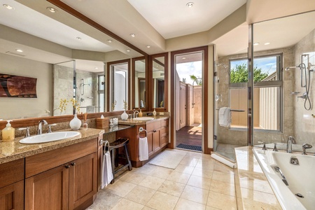 Primary bathroom with dual vanity, oversized soaking tub, private w/c, walk-in shower and outdoor shower.