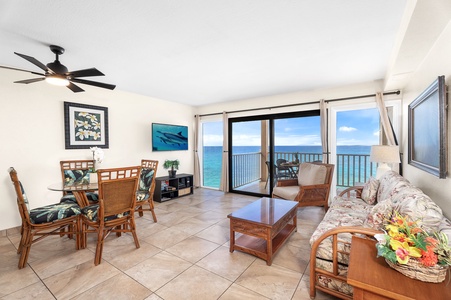 Open-concept living room with breezy coastal vibes, direct lanai access, and floor-to-ceiling ocean views.
