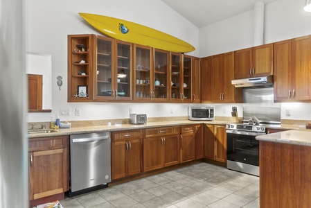 Chef-friendly kitchen with full appliances, surf-inspired decor, and ample storage.
