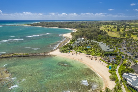 Quiet water inside the reef, open beach beyond it, and the coast just keeps going.