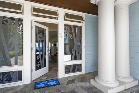 Entryway with a covered porch and double doors says 