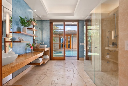 Primary ensuite with dual vanity and lanai access.