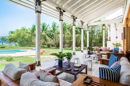 Enjoy the serene views of the lush garden and pool in the main patio.