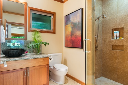 Refresh in the guest house bath with a walk-in shower and tropical-inspired details.