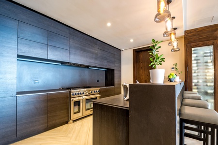 Cook in the sleek and modern kitchen, with a breakfast bar perfect for casual dining or entertaining guests.