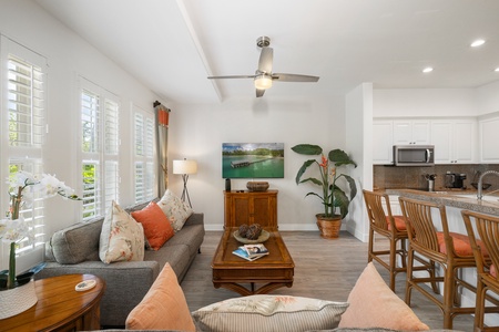 Inviting living room with warm tones and natural light, perfect for enjoying a movie night or just relaxing with a good book.