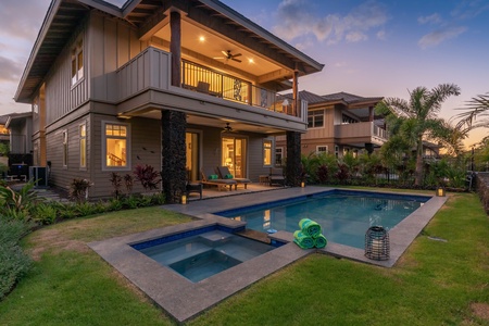 Alternate view of pool, jacuzzi and home at twilight.