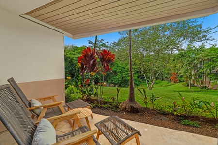 Ground-level lanai surrounded by lush landscaping and soft breezes.