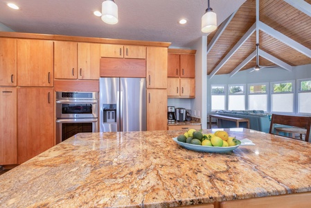 The kitchen features stainless steel appliances and ample cabinetry for storage.