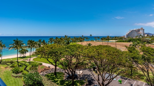 beach view showing off parking lot with resort in background