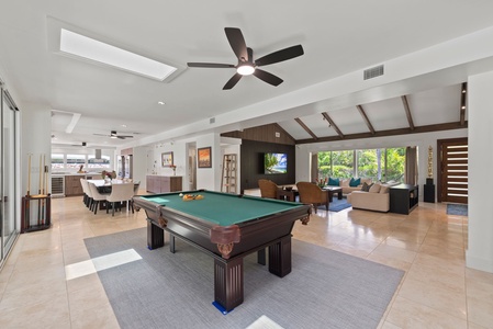 Enjoy fresh air meals day or night in this shaded lanai space with direct backyard access.