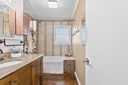 This guest bath features a tub and shower combination and is stocked with essentials for a relaxing stay.