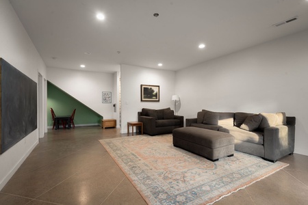 Unwind in your spacious media room with plush sectional seating and modern comfort for relaxing evenings indoors.