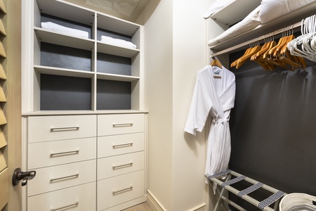 Spacious guest closet with built-in storage and thoughtful organization.