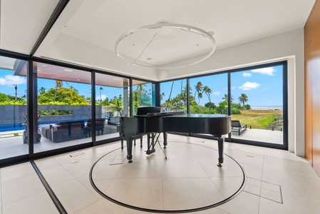 Thoughtful design allows for a light-filled music room with a grand piano and sweeping coastal views.