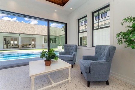 Cozy seating area just off the pool deck, ideal for reading or relaxing in the breeze.