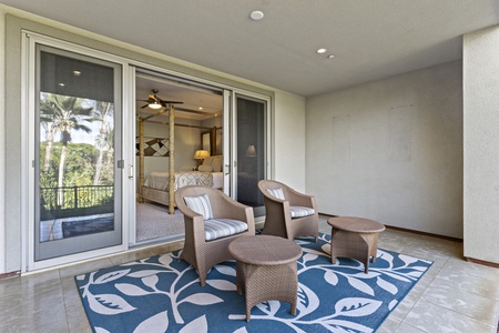 The primary bedroom's lanai, a perfect spot for morning coffee.