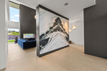 Gallery-style wall treatments and custom lighting transform each corridor into a modern exhibition space.