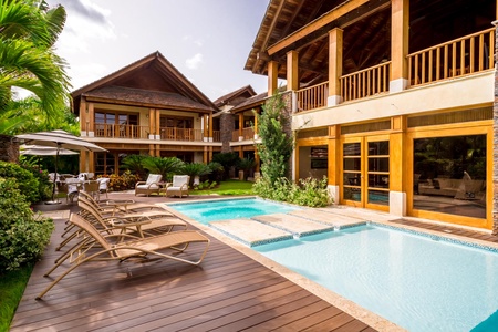 Gather in the bright living area leading to the pool and garden.