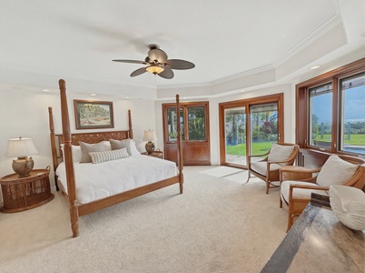 Unwind in your elegant bedroom where tropical breezes flow through expansive windows and rich wood details create warmth.