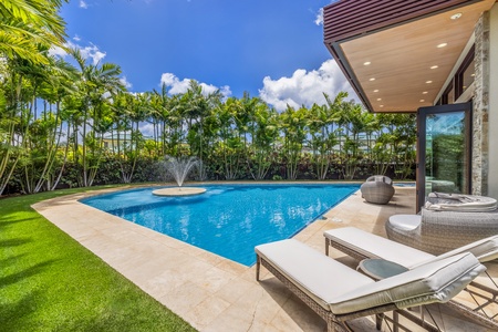 Soak up the sun by the private pool, complete with plush loungers for ultimate relaxation.