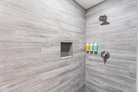 Stylish walk-in shower with modern tile—refreshing after a beach day.