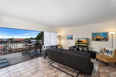 Cozy great room with plenty of natural light and direct lanai access for relaxing moments.