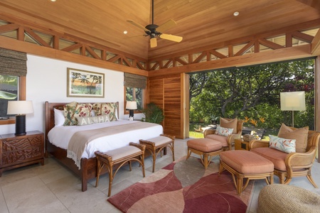 The primary suite boasts a sanctuary of tranquility, featuring lofted ceilings, a king bed and wall-to-wall sliders opening directly to the hot tub and pool.