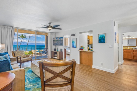 Royal Kahana 213’s open living area flows to the lanai, showcasing ocean views and abundant natural light.