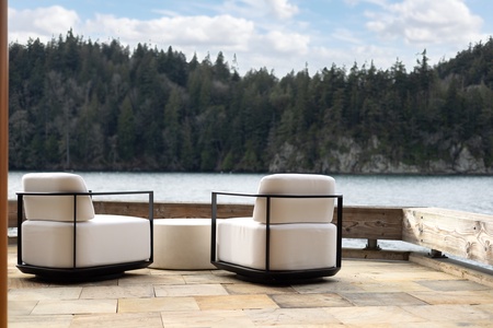 Relax in plush outdoor chairs while admiring the tranquil lake scenery.