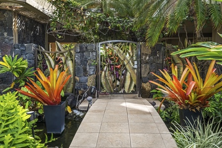 Beautifully landscaped pathway leading to the pool and communal areas, offering serene garden views.