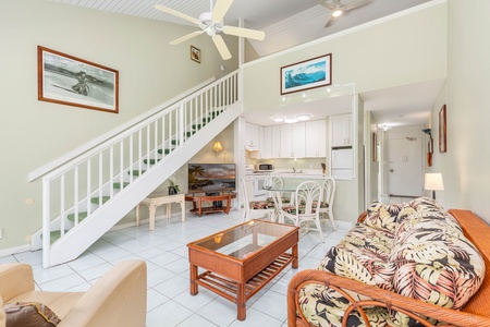 Bright and spacious living area with vaulted ceilings and tropical furnishings.